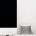 Modern therapy room with a computer, speaker, and bookshelf for relationship counselling.