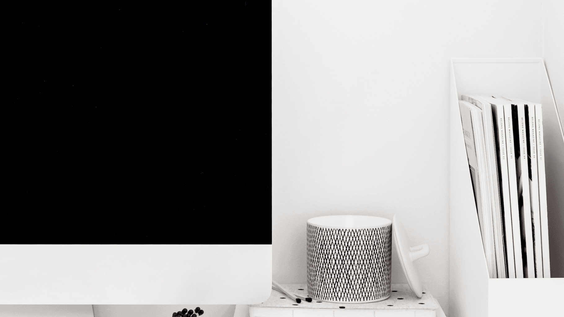 Modern therapy room with a computer, speaker, and bookshelf for relationship counselling.